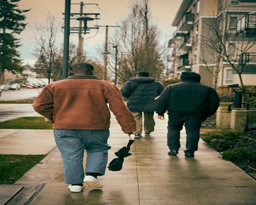 Person walking comfortably on a sidewalk in a residential area