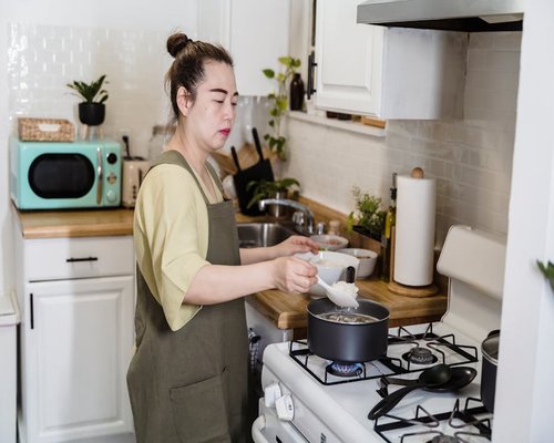 Someone cooking in a modern home kitchen